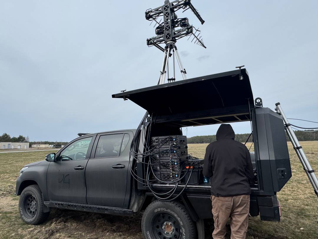 Defender reactive jamming system deployed on vehicle with directional antennas and mast — field operational configuration